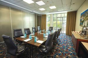 a conference room with a long table and chairs at Southern Sun Waterfront Cape Town in Cape Town