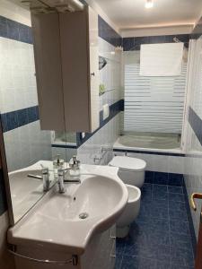 a bathroom with a sink and a toilet at V&V Pink House in San Mauro