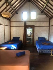 a room with two beds and a mirror at La Bohème in Gili Air +30 photos