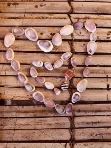 a heart made out of seashells on a table at La Bohème in Gili Air