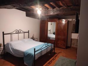a bedroom with a bed and a mirror in a room at La Casina in Fornello