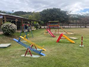 a park with a playground with a slide at Polaris Flat - Aldeia das Águas Park Resort in Barra do Piraí