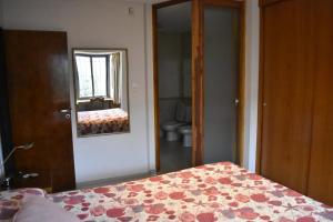 a bedroom with a bed and a mirror at Refugio Andino in Malargüe +7 photos