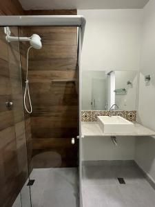 a bathroom with a sink and a shower at Vitor Moreira pousada campo verde ltda in São João del Rei