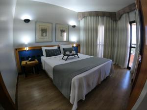 Un pat sau paturi într-o cameră la Bonaparte Hotel - Excelente Apartamento #1019