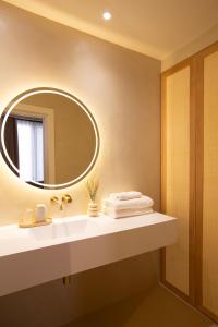 a bathroom with a sink and a mirror at Alux Boutique Hotel in Málaga