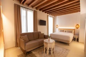 a living room with a bed and a couch at Alux Boutique Hotel in Málaga