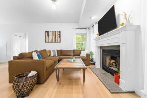 a living room with a couch and a fireplace at Gorogeous Chic 2BDR Renovated Home near Downtown Sleeps 6 843 in Traverse City