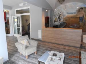 a living room with chairs and a painting on the wall at Hotel Marblau Tossa in Tossa de Mar