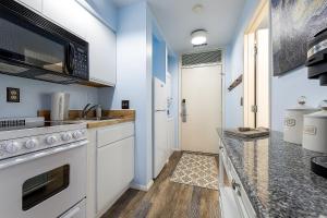 a kitchen with white cabinets and a counter top at Beautiful Lake View Studio Condo at The Shores in Traverse City