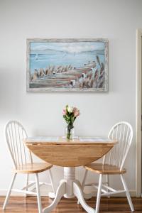 a table with two chairs and a vase of flowers at Beautiful Bay View Couples Retreat at The Shores 5586 in Traverse City
