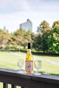 a bottle of wine and two glasses on a table at Beautiful 2BDR Loft Suite at Golf Course Condo 5549 in Traverse City