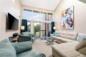 a living room with a couch and a tv at Beautiful 2BDR Loft Suite at Golf Course Condo 5549 in Traverse City