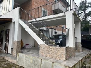 a house with a staircase with a car parked under it at Casa Filippini in Bologna