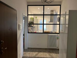 a hallway with a large window and a radiator at Casa Filippini in Bologna +6 photos