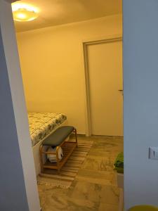 a small room with a bed and a door at Casa Filippini in Bologna