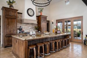 a kitchen with a large island with bar stools at Grand Reserve Inn in Plymouth