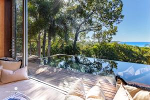 a balcony with a view of the ocean from a house at Ocean Ridge Property in Agnes Water