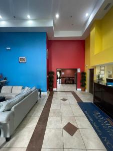 a lobby with a couch and colorful walls at Winston Salem Inn & Suites in Winston-Salem