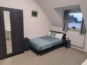 a small bedroom with a bed and a window at Studio Apartment 23 - 3R2 in Essen