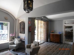 a living room with two chairs and a dresser at Hotel Marblau Tossa in Tossa de Mar