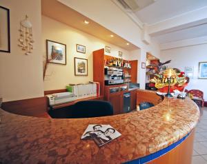 a kitchen and living room with a counter top at Hotel Villa Gioiosa - Beach & Bistrot in Rimini