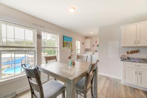 a kitchen and dining room with a table and chairs at Coastal Emerald Isle Retreat with Deck and Grill! in Emerald Isle