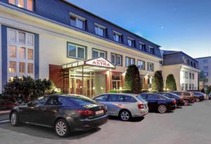 a row of cars parked in front of a building at Hotel Astra in Prague