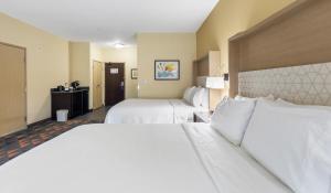a hotel room with two beds with white sheets at Holiday Inn Hotel & Suites Waco Northwest by IHG in Bellmead