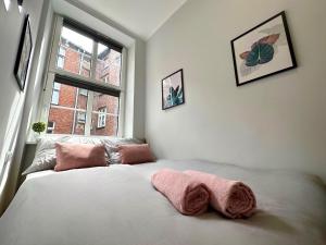 a bedroom with a large bed with a window at MMRent Merci Room in Gdańsk