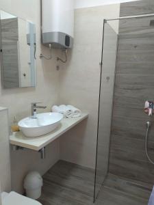 a bathroom with a sink and a shower at Apartments with a parking space Njivice, Krk - 14932 in Njivice