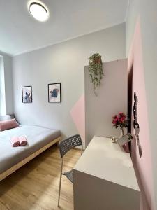 a small room with a bed and a desk at MMRent Merci Room in Gdańsk