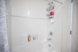 a white bathroom with a tub and a sink at Beautiful Brand New 2 Bedroom Vegas Home! Fits 12 or more,15-20 minutes from LV Strip in Las Vegas
