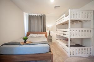 a bedroom with a white bunk bed and a ladder at Beautiful Brand New 2 Bedroom Vegas Home! Fits 12 or more,15-20 minutes from LV Strip in Las Vegas