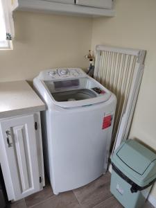 a washer and dryer in a kitchen next to a counter at Belle Cove in Gros Islet