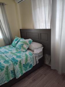 a bedroom with a bed and a window with a bedskirtspectspectspectspects at Belle Cove in Gros Islet
