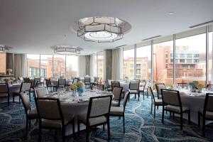 a conference room with tables and chairs and windows at Ithaca Marriott Downtown on the Commons in Ithaca