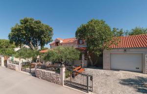 a house with a fence and a garage at Luxury villa with a swimming pool Skrip, Brac - 17350 in Postira
