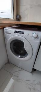 a washing machine in a room with a window at Beautiful & cosy 3 bedrooms full accommodation in Ris-Orangis