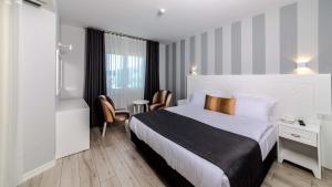 Кровать или кровати в номере Motto Premium Hotel&Spa
