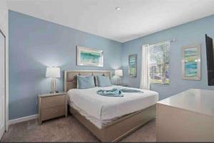 a blue bedroom with a bed and a window at Disney 8BR South Pool Theater Arcade Harry Potter Room in Davenport +47 photos