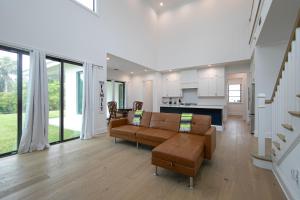 a living room with a couch and a table at Ocean Estate in Fort Pierce