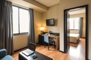 a hotel room with a laptop computer on a desk at Hotel Lisboa in Lisbon