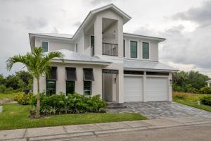 a white house with a garage at Ocean Estate in Fort Pierce