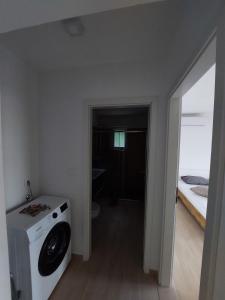 a bathroom with a washing machine in a room at Apartments with parking space Borje, Peljesac - 21496 in Orebić +8 photos