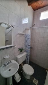 a bathroom with a sink and a toilet and a mirror at Hospedaje Guandacol in Guandacol