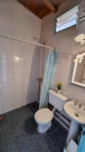 a bathroom with a toilet and a sink at Hospedaje Guandacol in Guandacol