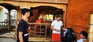 un groupe de personnes debout à l'extérieur d'un bâtiment dans l'établissement Bambooze Hauz, à Boracay