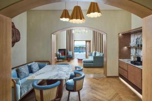 a living room with a table and a dining room at Sheraton Miramar Resort El Gouna in Hurghada