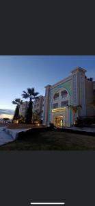 a large building with a clock on the front of it at Appartement Résidence Palm Lake Monastir in Monastir